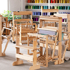 Weaving space with several wooden floor looms 